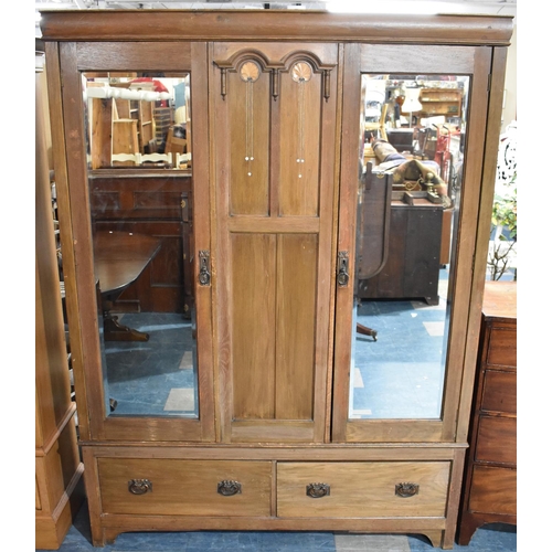 473 - An Arts and Crafts Influenced Oak Triple Wardrobe with two Base Drawers, Two Mirrored Doors to hangi... 