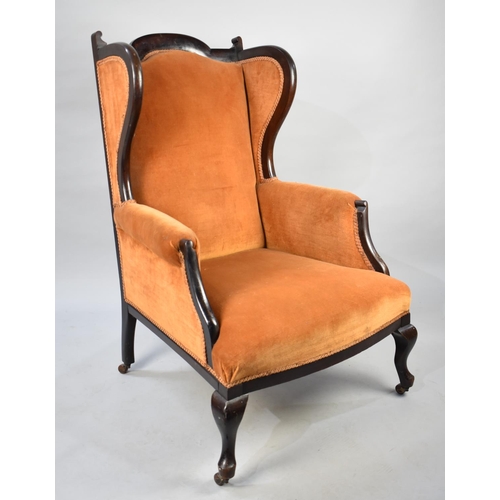 515 - An Edwardian Mahogany Farmed Wing Armchair