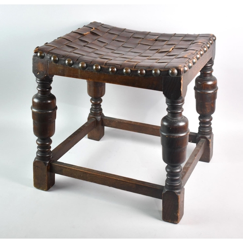 77 - A Vintage Oak Framed Rectangular Stool with Brass Stud and Leather Woven Top, Condition issue to One... 