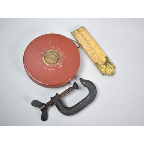 87 - A Leather Cased 100' Tape Measure, a Small G Clamp and a Folding Rabone Ruler