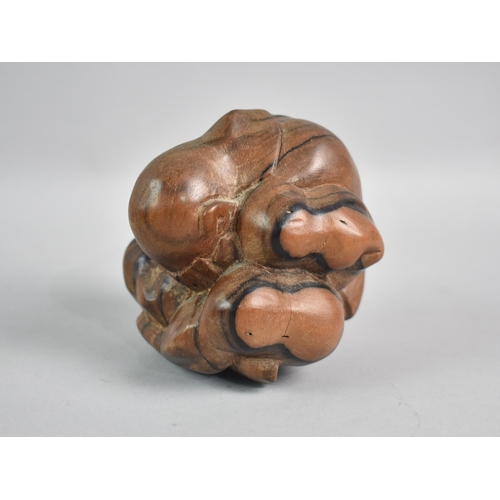 65 - A Carved Far Eastern Hardwood Sculpture of Figure Hunched up, 9cm High