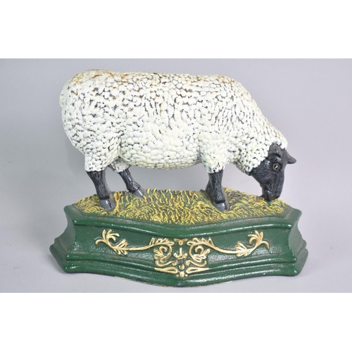 115 - A Modern Cold Painted Cast Iron Doorstop in the Form of a Grazing Black Faced Sheep, 27cms Wide