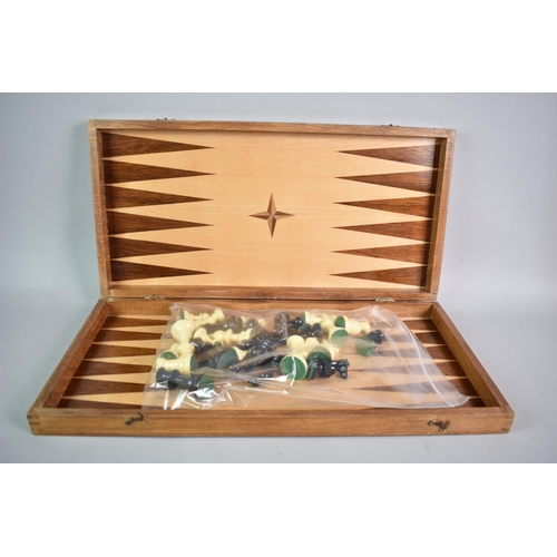 166 - A Wooden Combination Chess and Backgammon Board Containing Playing Pieces, 48cms Square