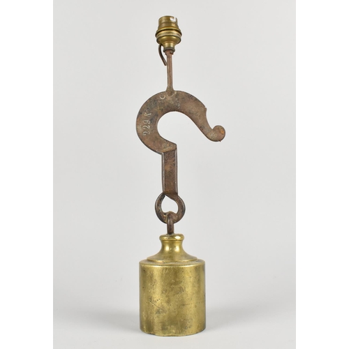 18 - A Novelty Table Lamp Base formed From a Brass Cylindrical Weight and a Cast Iron Hook, 37cms High