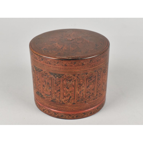 30 - A Cylindrical Lidded Thai Box in Red Lacquer with Gilt Decoration, Somewhat Faded, 10cms Diameter an... 