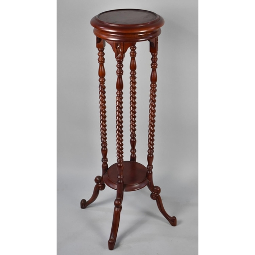 70 - A Reproduction Mahogany Circular Topped Torchere Stand on Scrolled Feet, 100cms High