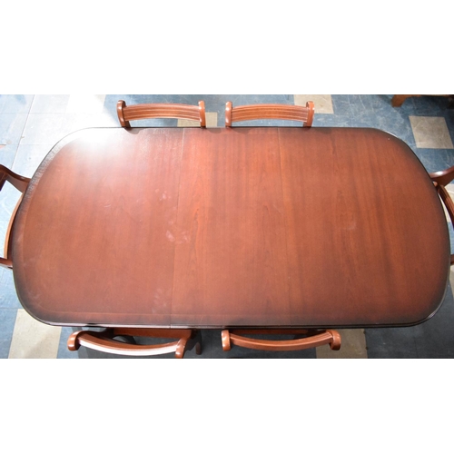 424 - An Oval Mahogany extending Dining Table with One Extra Leaf together with a Set of Six Chairs