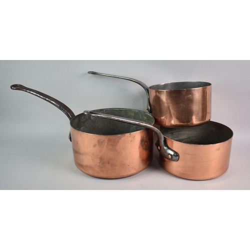 134 - A Collection of Three Victorian Graduated Copper Saucepans with Iron Handles, Largest 23cms Diameter