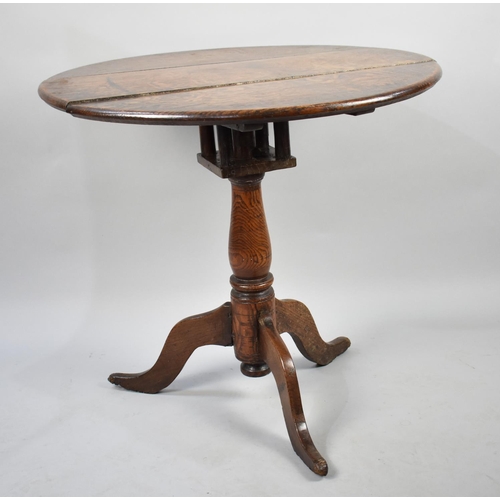 423 - A 19th Century Oak Snap Top Tripod Table with Birdcage Support, 74cms Diameter