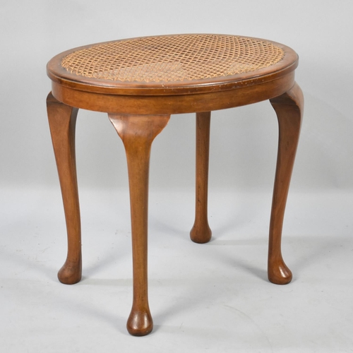 425 - A Mid 20th Century Walnut Framed Oval Dressing Table Stool with Caned Top, 48cms Wide