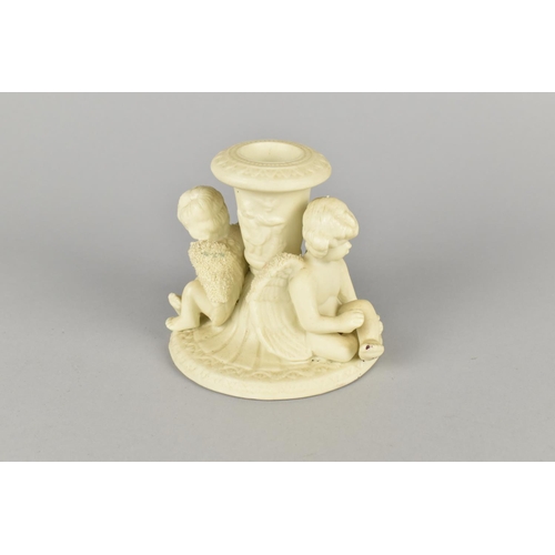 70 - A Moulded Parian Style Candlestick Decorated with Two Seated Cherubs, 9cms High