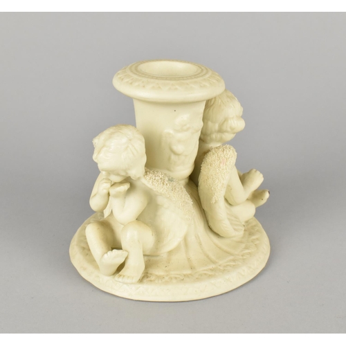 70 - A Moulded Parian Style Candlestick Decorated with Two Seated Cherubs, 9cms High