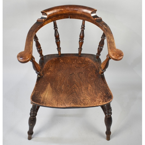 82 - A Late 19th Century/20th Century Elm Seated Spindle Back Smokers Bow Armchair