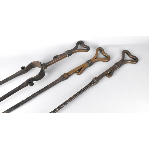 95 - A Set of Three Arts and Crafts Influenced Wrought Iron Fire Irons Having Stylised Heart Motif Finial... 