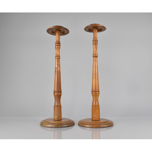 64 - A Pair of Early 20th Century Turned Wooden Wig Stands, 50cm high