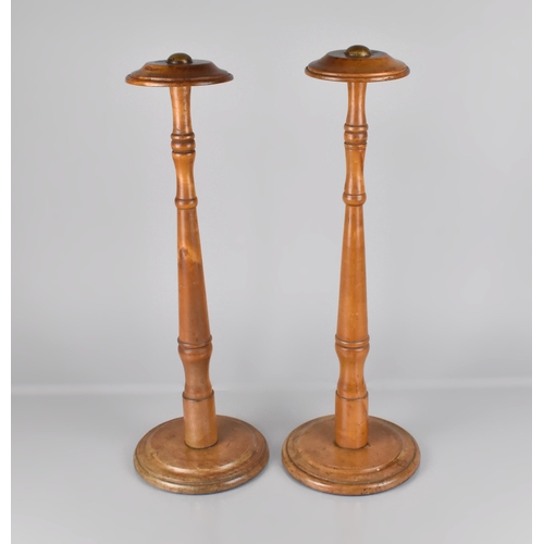 64 - A Pair of Early 20th Century Turned Wooden Wig Stands, 50cm high