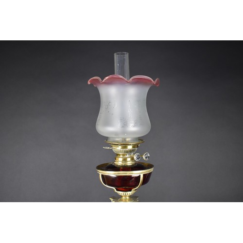 11 - A Late 19th Century Wright & Butler of Birmingham Brass Oil Lamp with Ruby Glass Reservoir on Corint... 