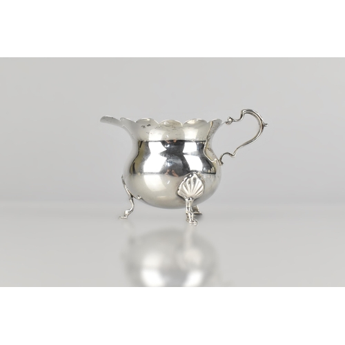 141 - An Edward VII Silver Jug by D&M (David & Maurice Davis), Raised on Three Short Cabriole Supports to ... 