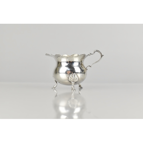 141 - An Edward VII Silver Jug by D&M (David & Maurice Davis), Raised on Three Short Cabriole Supports to ... 