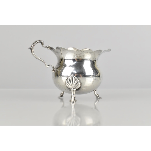 141 - An Edward VII Silver Jug by D&M (David & Maurice Davis), Raised on Three Short Cabriole Supports to ... 