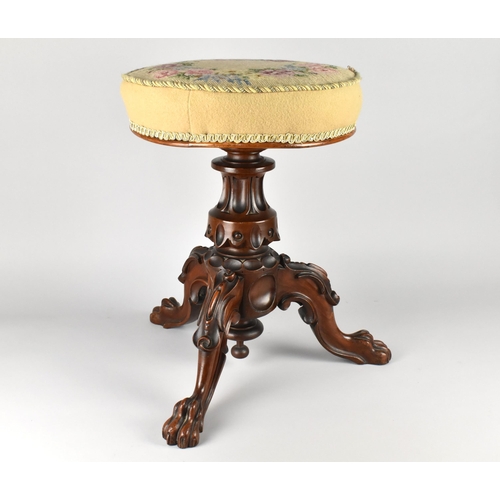 74 - A 19th Century Tapestry Topped Piano Stool with Carved Support Having Claw Feet, 50cm high and 36cm ... 