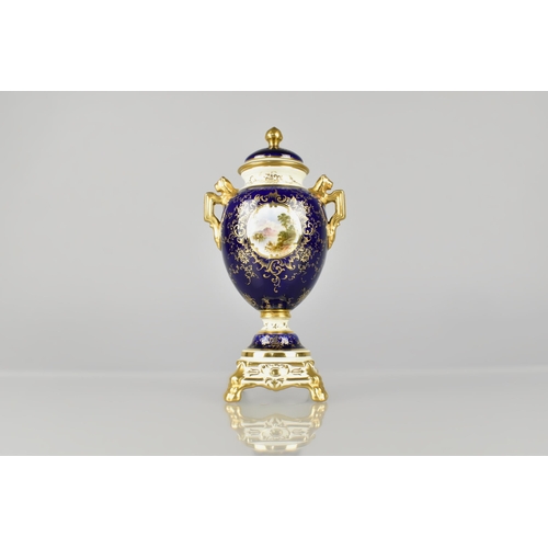 204 - A Coalport Lidded Urn Shaped Vase Decorated with Landscape Cartouche on Blue Ground with Cream Trim ... 