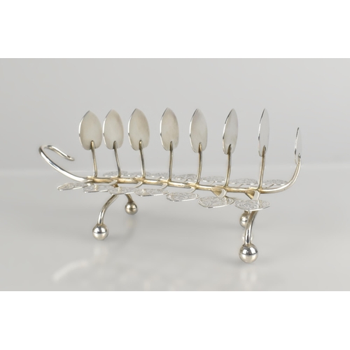 129 - A White Metal Eight Bar Toast Rack of Naturalistic Leaf and Tendril Form on Bun Feet with Engraved D... 