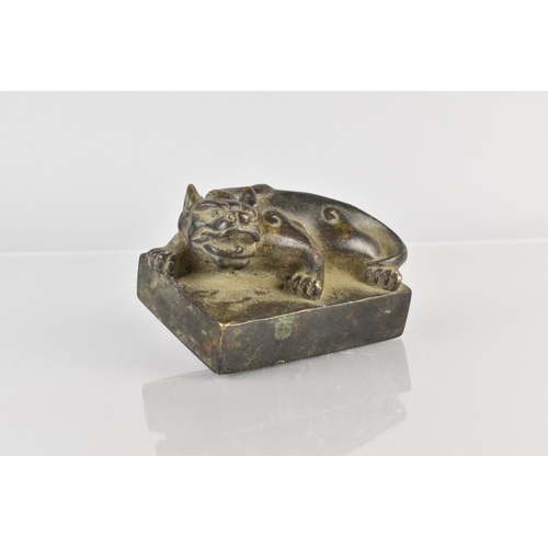 177 - An Archaic Chinese Bronze Seal Modelled as a Crouching Mythical Lion, 10x7x6cm high