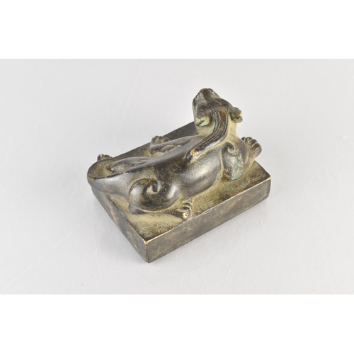 177 - An Archaic Chinese Bronze Seal Modelled as a Crouching Mythical Lion, 10x7x6cm high