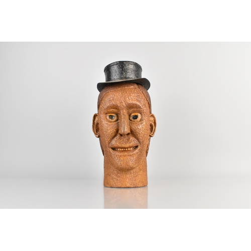 36 - An Interesting Folk Art Carved Oak Male Head, Wearing a Painted Metal Wide Brimmed Hat, 27cm high