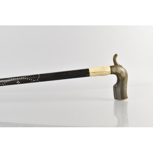 62 - A 19th Century Ceylonese Walking Stick with a Shaped Horn Handle Inlaid with Sadeli Roundels and wit... 