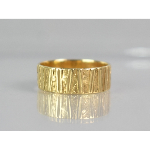 295 - An 18ct Gold Textured Wedding Band, London Hallmark for 1972 and Makers Mark EJ, 4.1gms