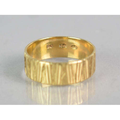 295 - An 18ct Gold Textured Wedding Band, London Hallmark for 1972 and Makers Mark EJ, 4.1gms