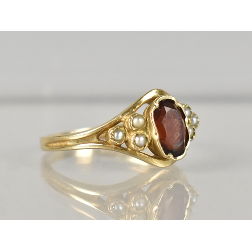 281 - A 9ct Gold, Garnet and Seed Pearl Ladies Ring, Oval Cut Garnet Measuring 6.5mm by 4.25mm, Set in Cri... 