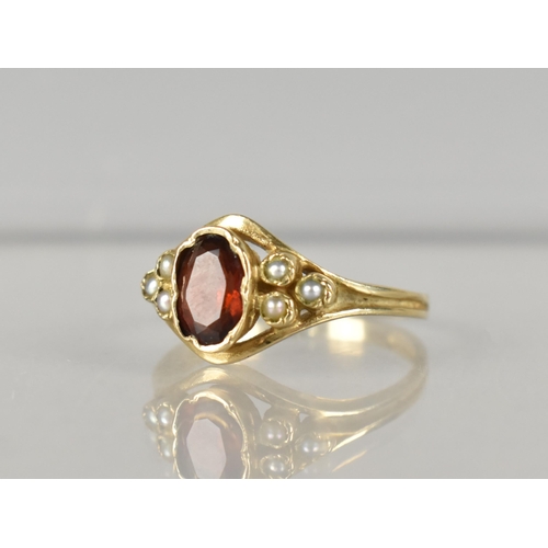 281 - A 9ct Gold, Garnet and Seed Pearl Ladies Ring, Oval Cut Garnet Measuring 6.5mm by 4.25mm, Set in Cri... 