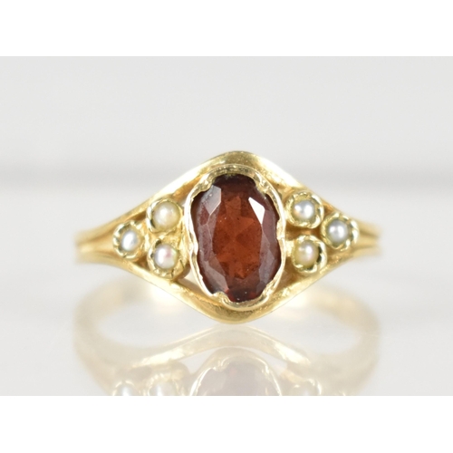 281 - A 9ct Gold, Garnet and Seed Pearl Ladies Ring, Oval Cut Garnet Measuring 6.5mm by 4.25mm, Set in Cri... 