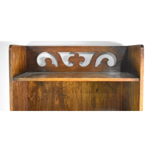 42 - An Edwardian Oak Combination Bookshelf and Magazine Rack with Raised Pierced Gallery, 46cms Wide and... 