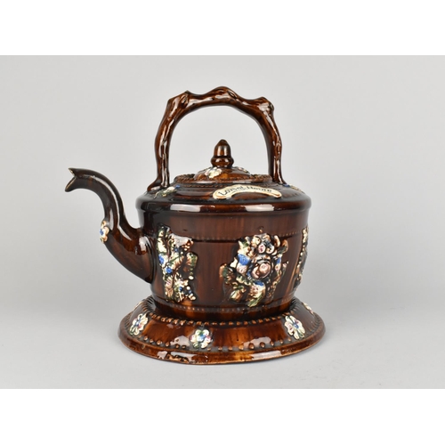 67 - A Treacle Glazed Measham Teapot and Stand, 