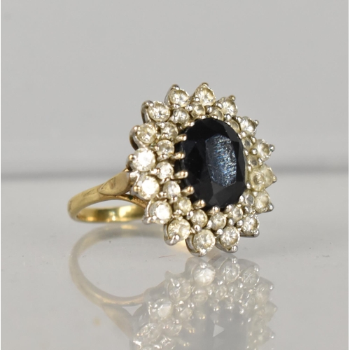 490 - A Large 9ct Gold Sapphire and CZ Cluster Ring, Oval Cut Centre Stone Measuring 10mm by 8.2mm Approx ... 