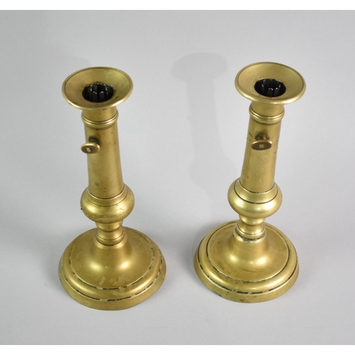 50 - A Pair of 19th Century Brass Candlesticks with Twist Candle Grippers, 22cms High