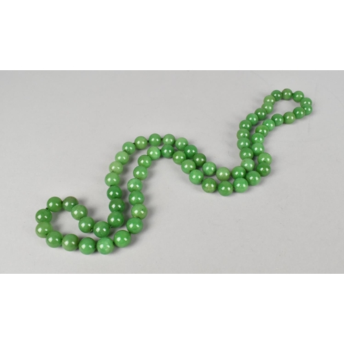 505 - A String of Simulated Jade Green Stone Beads on a Knotted Green Thread, 84cms Long Approx