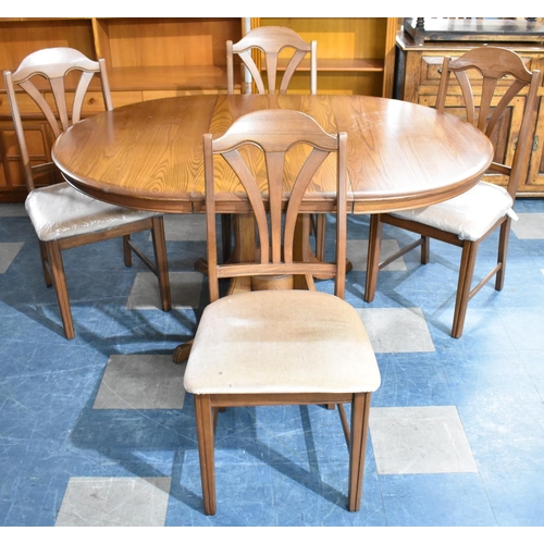 581 - An Extending Cousins and Matthews Oval Dining Table and Four Chairs