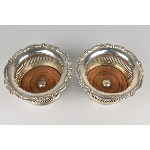 31 - A Pair of Sheffield Plated Wine Coasters with Turned Wooden Bases, Pierced Bellies and Scrolled Trim... 