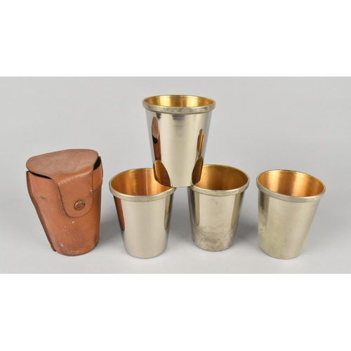 18 - A Leather Cased Set of Four Silver Plated Stacking Beakers, each 9.25cm High