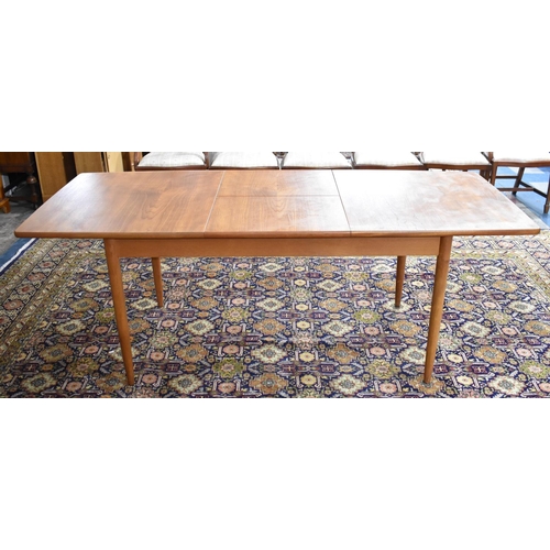 477 - A 1970s Teak Extending Dining Table on Turned Supports