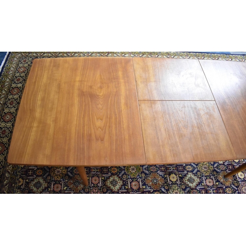 477 - A 1970s Teak Extending Dining Table on Turned Supports