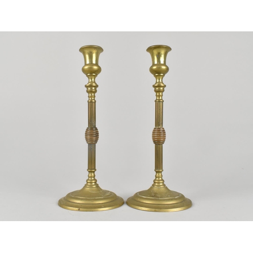 62 - A Pair of Brass Candlesticks with Reeded Supports, 21.5cms HIgh