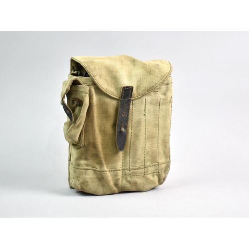 94 - A Military Four Cell Magazine Pouch Containing Four Spent Magazines