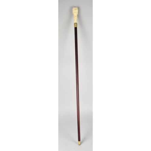 96 - A Bone Effect Handled Walking Stick in the Form of a Clenched Fist Holding Serpent, 97.5cms Long