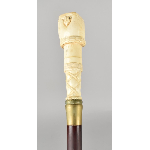 96 - A Bone Effect Handled Walking Stick in the Form of a Clenched Fist Holding Serpent, 97.5cms Long